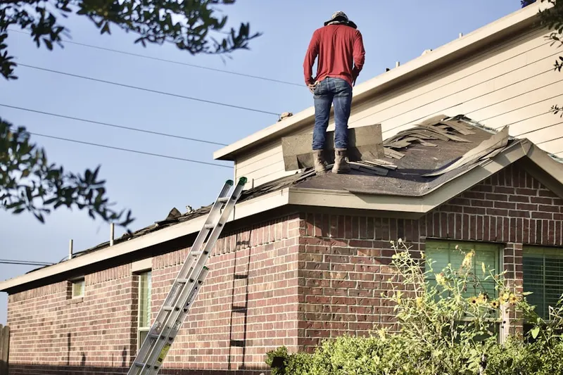 Professional roofer working on a residential roof in Monocacy
